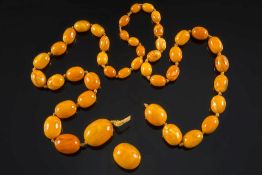 A graduated amber bead single string necklace: with 44 oblong beads, the largest bead 30.