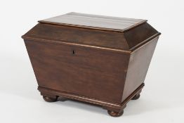 An early Victorian mahogany sarcophagus shaped cellarette:,