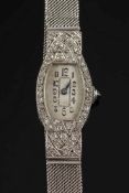A lady's platinum and diamond mounted cocktail wristwatch: the rounded,