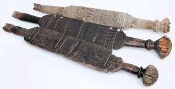 Three Touareg tent posts: of traditional design, with incised geometric decoration 70cm, 80cm, 80cm.