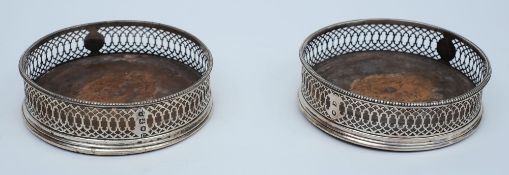 A pair of 18th century silver circular pierce work wine coasters, maker possibly John Lambe,
