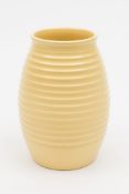 A Keith Murray for Wedgwood annular vase: the lemon glazed body of ribbed oviform,