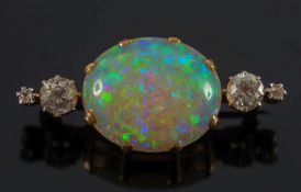 A gold, opal and diamond bar brooch: with central oval opal approximately 19mm x 15.