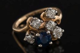 A sapphire and diamond mounted informal cluster ring: with single,