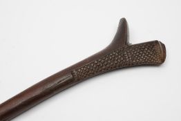 A Fijian Gata war club: of traditional gunstock design with carved geometric decoration to the head,