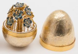 A Stuart Devlin silver-gilt egg, London, 1979: the interior with enamelled floral spray, 7.5cm.