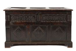 An antique oak rectangular coffer:, with a plain triple moulded panel hinged top,