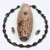 An Indo/Tibet prayer stone: of ovoid form with banded circular decoration, 18cm.