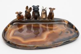 A polished agate oval-shaped dish:  applied with five dogs in the style of Boris O'Klein's Dirty