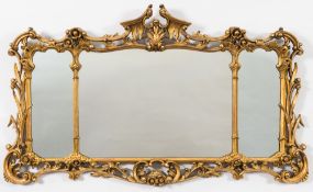 A carved giltwood landscape mirror of cartouche outline in the Chippendale taste:,
