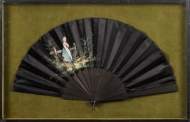 A late 19th century black satin fan: the leaf painted with a figure of a young woman leaning on a
