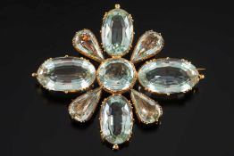 A mid 19th century gold and aquamarine quatre-foil brooch: with oval and pear-shaped aquamarines in