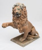 A large polychrome painted metal statue of a seated lion:, with raised right paw,