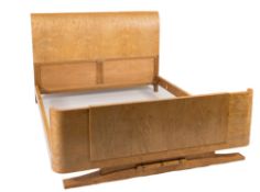 An Art Deco burr maple king size bed:, with shaped head and foot boards,