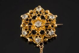 A late 19th century gold and diamond mounted circular brooch: of openwork design,