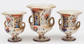 A garniture of three Derby vases: of campana form with gilt serpent handles,