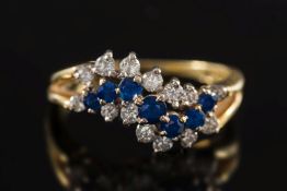 An 18ct gold, sapphire and diamond mounted informal cluster ring:, ring size P.