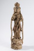 A Chinese carved wood figure of Kuan-Yin: in flowing robes, standing on a lotus flower,