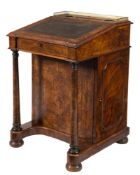 A Victorian walnut and inlaid Davenport:, bordered with boxwood lines,