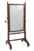 An early 19th Century mahogany swing frame cheval mirror:,