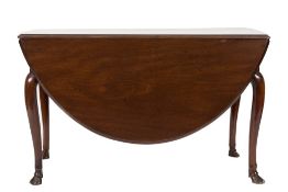 A George II mahogany drop flap dining table:, the oval hinged top with a moulded edge,