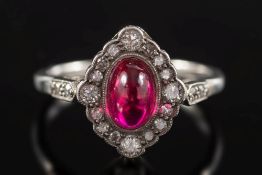 A synthetic ruby and diamond, oval cluster ring:,