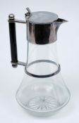 A late Victorian clear glass and silver plated claret jug in the Christopher Dresser style: with