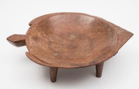 A Fijian carved hardwood bowl: of turtle-shaped outline, raised on four peg feet, 53cm. wide.