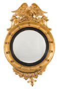 A Regency carved giltwood and gesso circular convex mirror:,