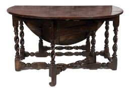 A Charles II oak oval gateleg table:, the hinged top on spirally turned underframing,