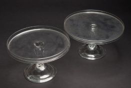 A pair of English clear glass tazze: each of circular galleried form on hollow vertical ribbed and