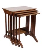 A set of amobyna wood and brass bound quartetto tables:, with quarter veneered tops,