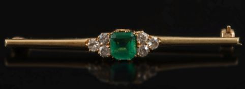 An emerald and diamond mounted bar brooch: with central square emerald between triple clusters of