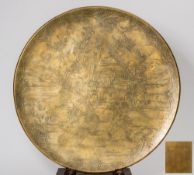 A Japanese bronze circular charger: decorated with figures playing a form of ball game beside a
