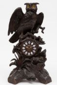 A Victorian carved oak mantel clock mounted with owls: the eight-day duration movement striking the