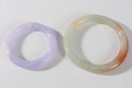 A Chinese lavender jadeite small bangle or ring and a celadon and russet jadeite bangle: the first