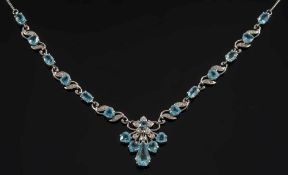 An 18ct white gold,  aquamarine and diamond necklace: with links of openwork scroll design,