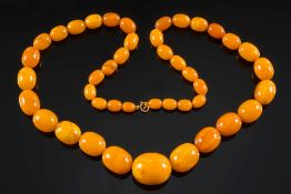 A graduated amber bead single string necklace: with 43 oblong beads, the largest bead 32.
