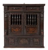 A 17th Century carved oak and marquetry food cupboard:,