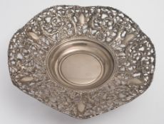 A Spanish white metal dish: of circular form with pierced decoration of dancing fairies,