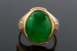 A gentleman's jade and diamond ring: with central oval green jade panel, approximately 16mm x 13mm,