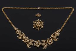 A late Victorian gold and seed pearl mounted floral necklet: with matching pendant/brooch.