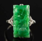 An early 20th century carved jade and diamond ring: with central rectangular jade panel between