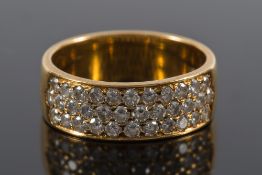 An 18ct gold and diamond mounted band ring: with three rows of circular brilliant-cut diamonds
