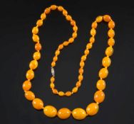 A graduated amber bead single string necklace: with 55 oblong beads,