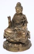 A Chinese bronze figure of Buddha: wearing traditional robes, seated cross legged on a lotus flower,