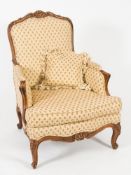 By Peter Dudgeon, London - A carved beechwood bergere armchair:, in the Louis XV provincial taste,