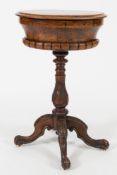 A Victorian walnut oval teapoy:,