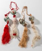 A group of four Chinese interior painted glass pendant ornaments: hung from two tasselled silk