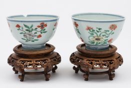 A pair of Chinese famille verte bowls: each painted in green, aubergine,